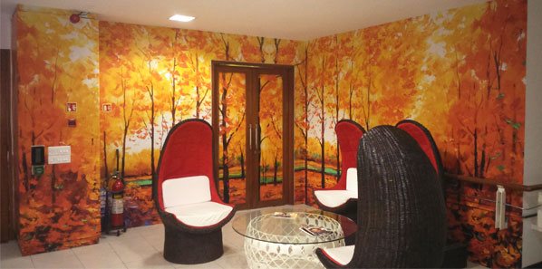 EdgeVerve office — autumn-forest wall mural in a breakout lounge