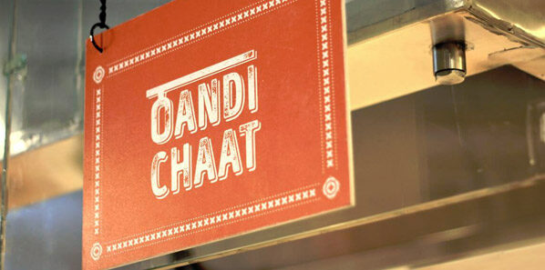 Framed desi-illustration graphic system installed across the Nookad Nation dining wall.